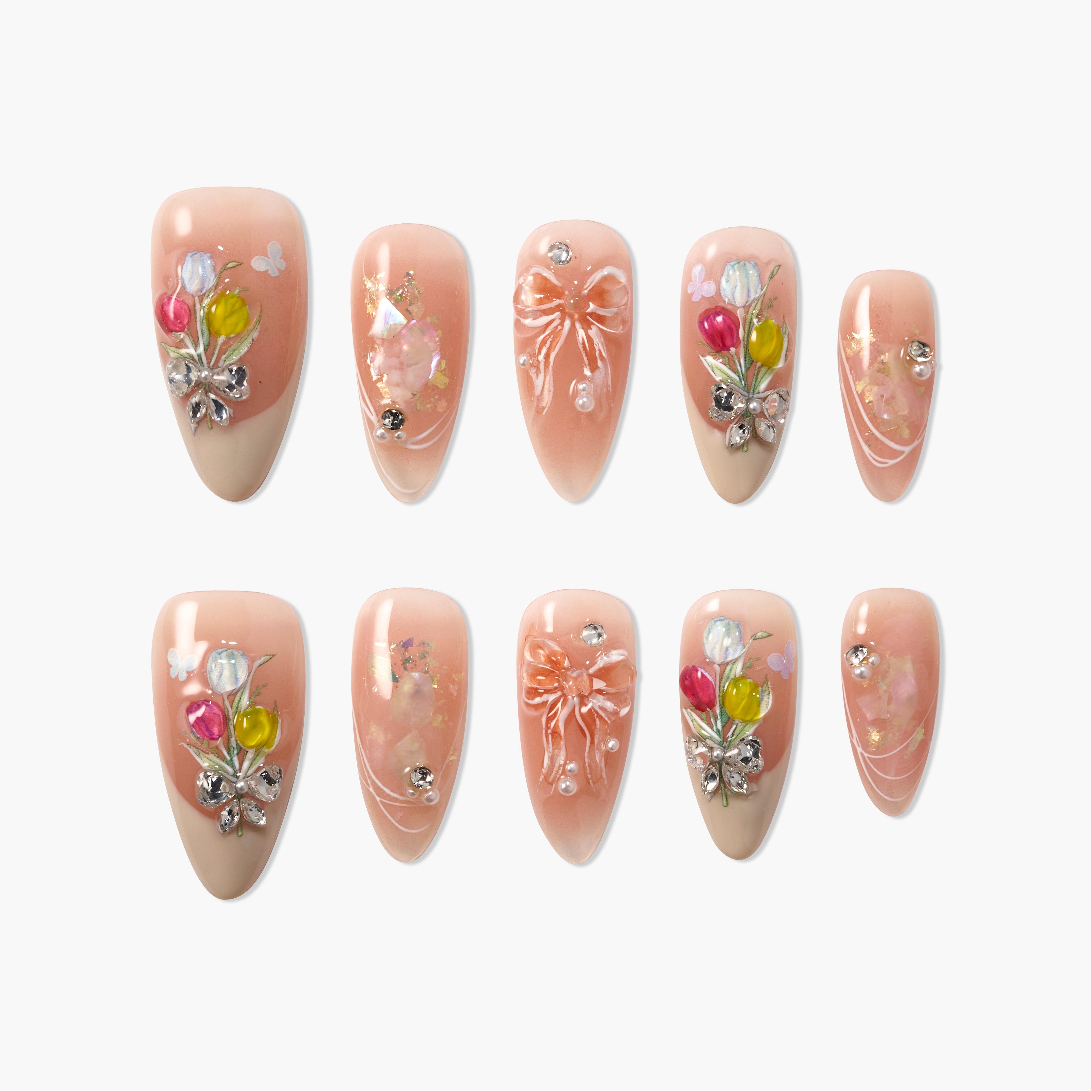 Peach pink press-on nails with 3D floral, bow, pearl, and rhinestone decorations