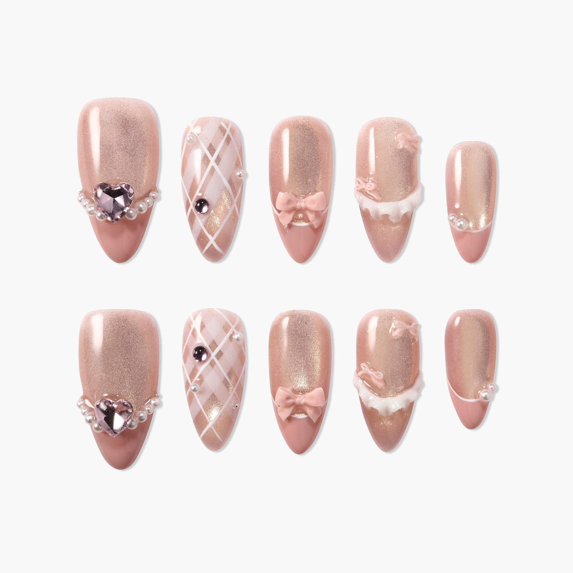 Handmade pink press-on nails with glitter, pearl accents, bows, and plaid patterns