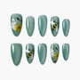 Green press-on nails with sunflower, bee, and floral hand-painted designs