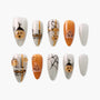 Handmade Halloween press-on nails with pumpkin faces, spider web, orange and silver glitter design