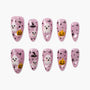 Pink Halloween press-on nails featuring ghosts, pumpkins, witch hats, and black dots