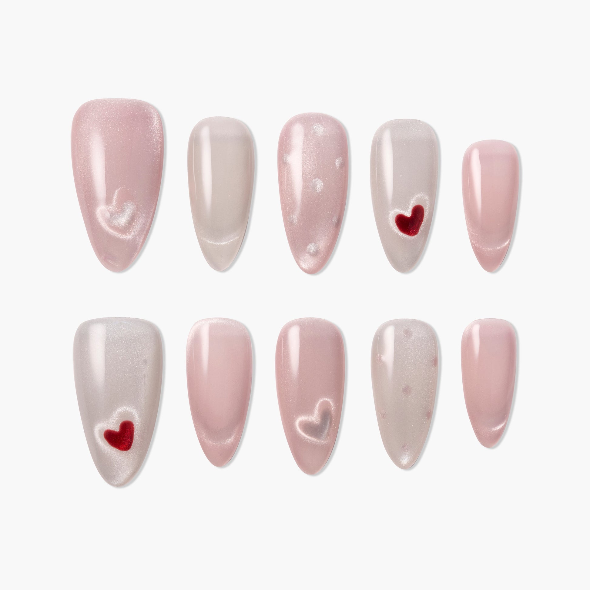 Handmade press-on nails in pink and nude tones with heart and polka dot designs, glossy finish