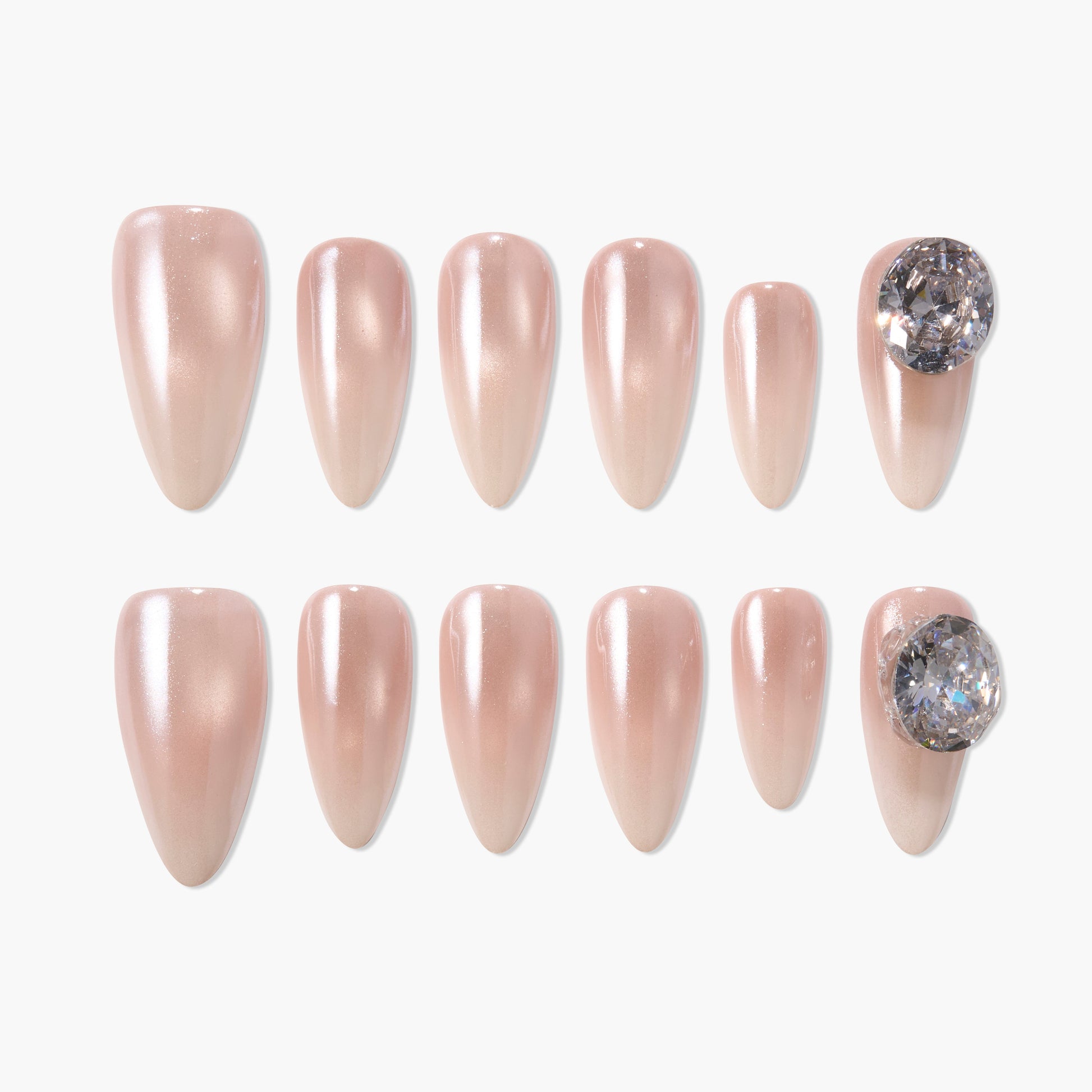 Glossy nude press-on nails set with clear gemstone accent, oval shape, elegant nail design
