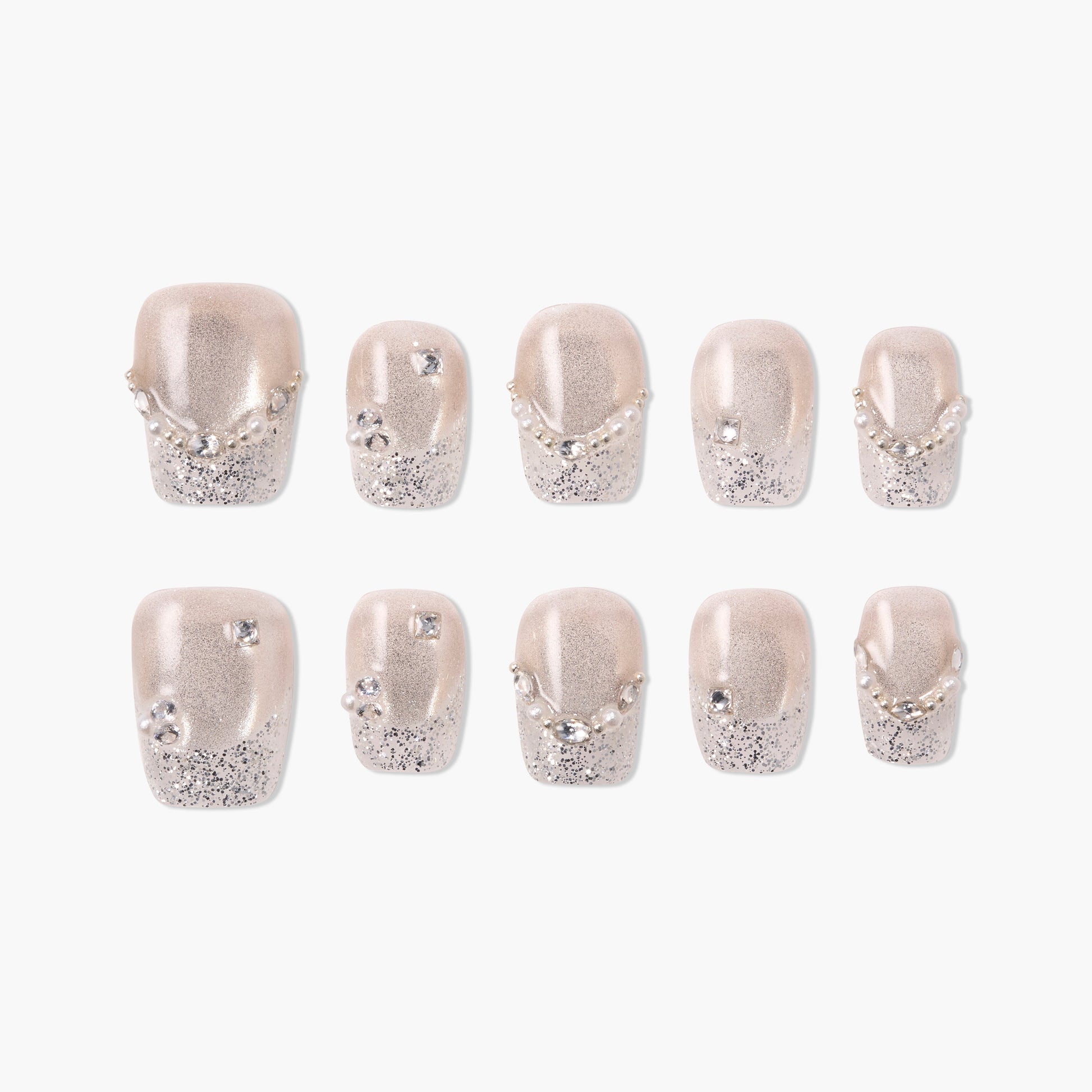 Handmade press-on nails with nude base, silver glitter tips, pearls, and rhinestone accents