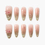 Pink and green ombre press-on nails with 3D flower, pearls, and leaf accents