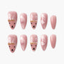 Pink press-on nails with cute bunny faces and gold accents, glossy finish, playful nail art