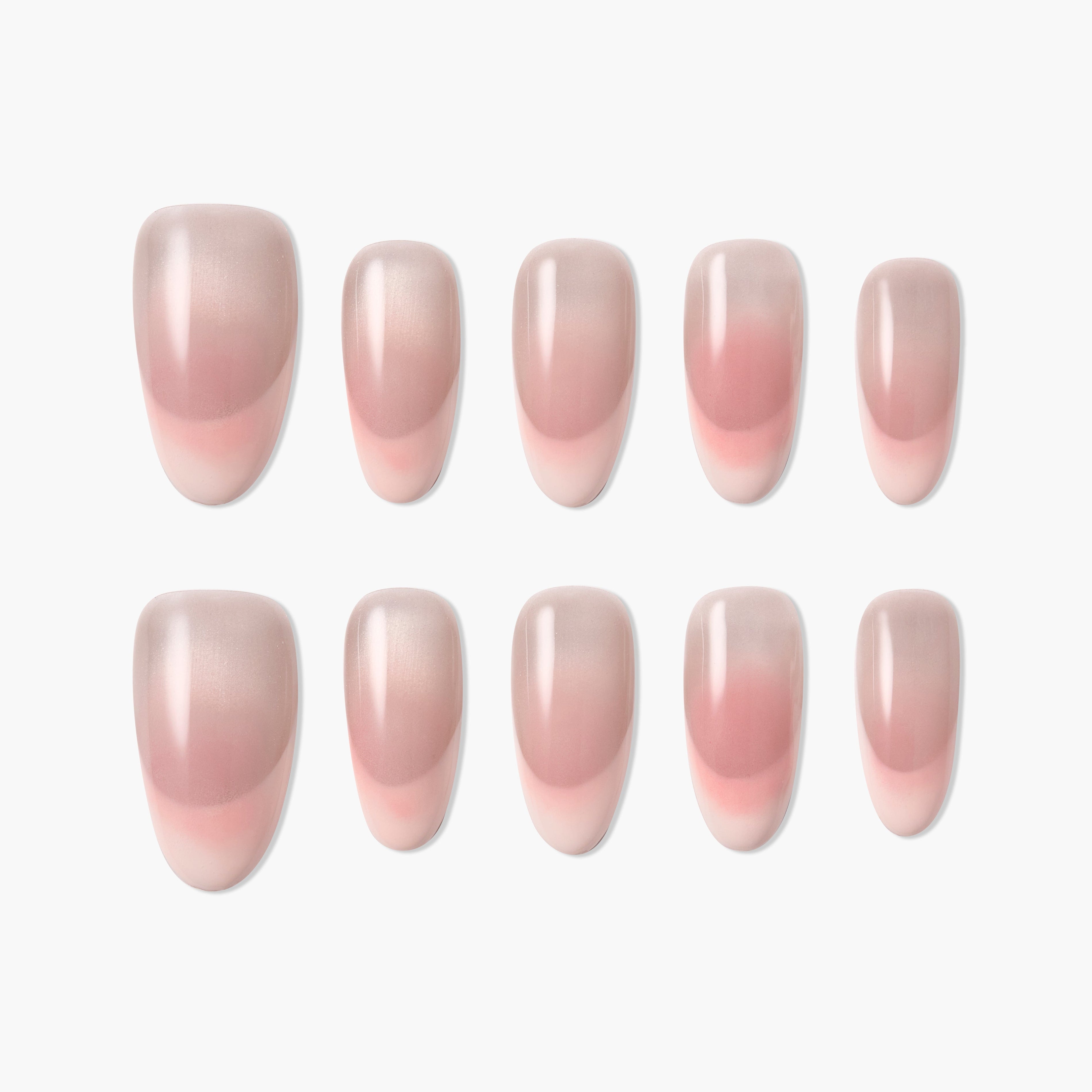 Set of glossy pink ombre press-on nails arranged on a white background