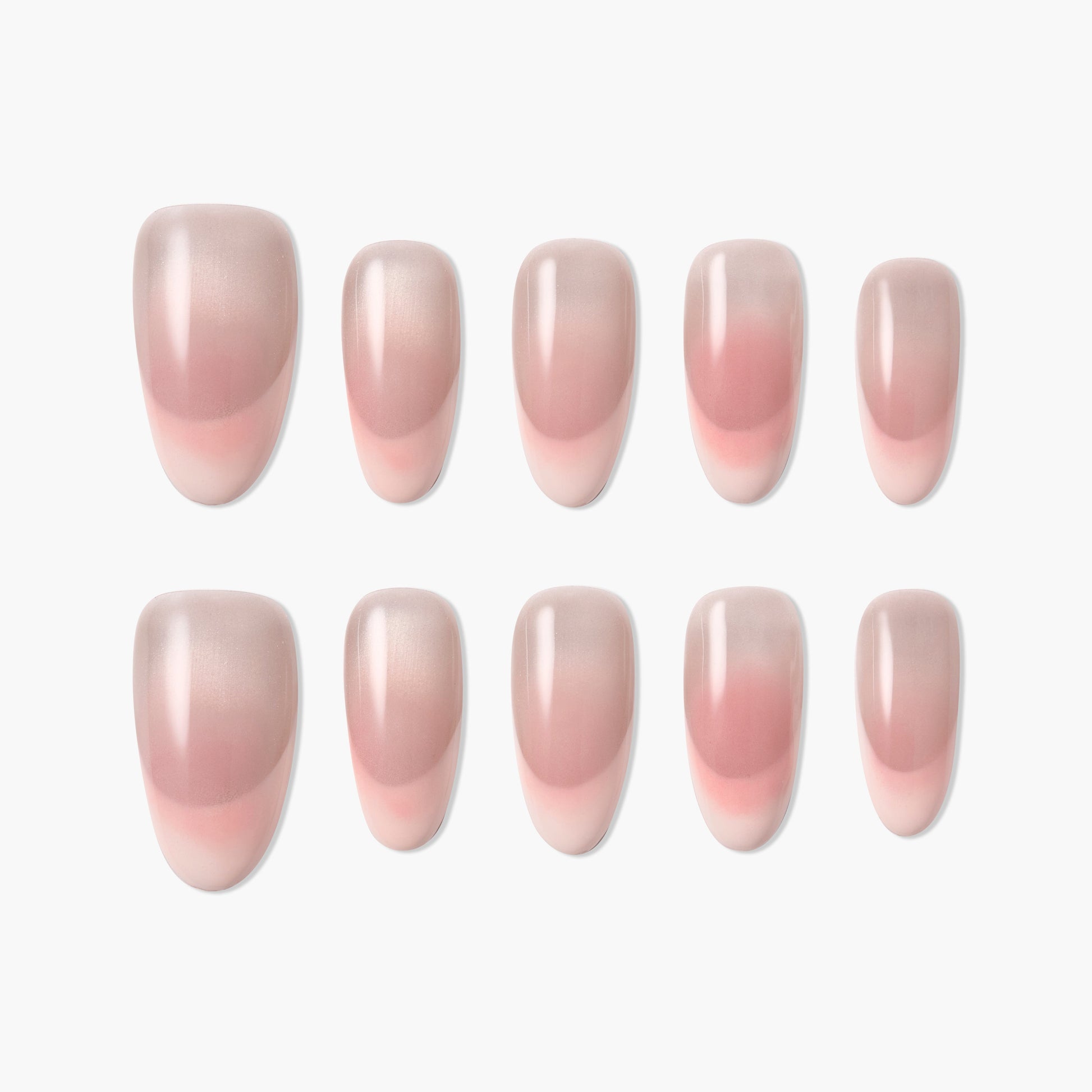 Set of glossy pink ombre press-on nails arranged on a white background