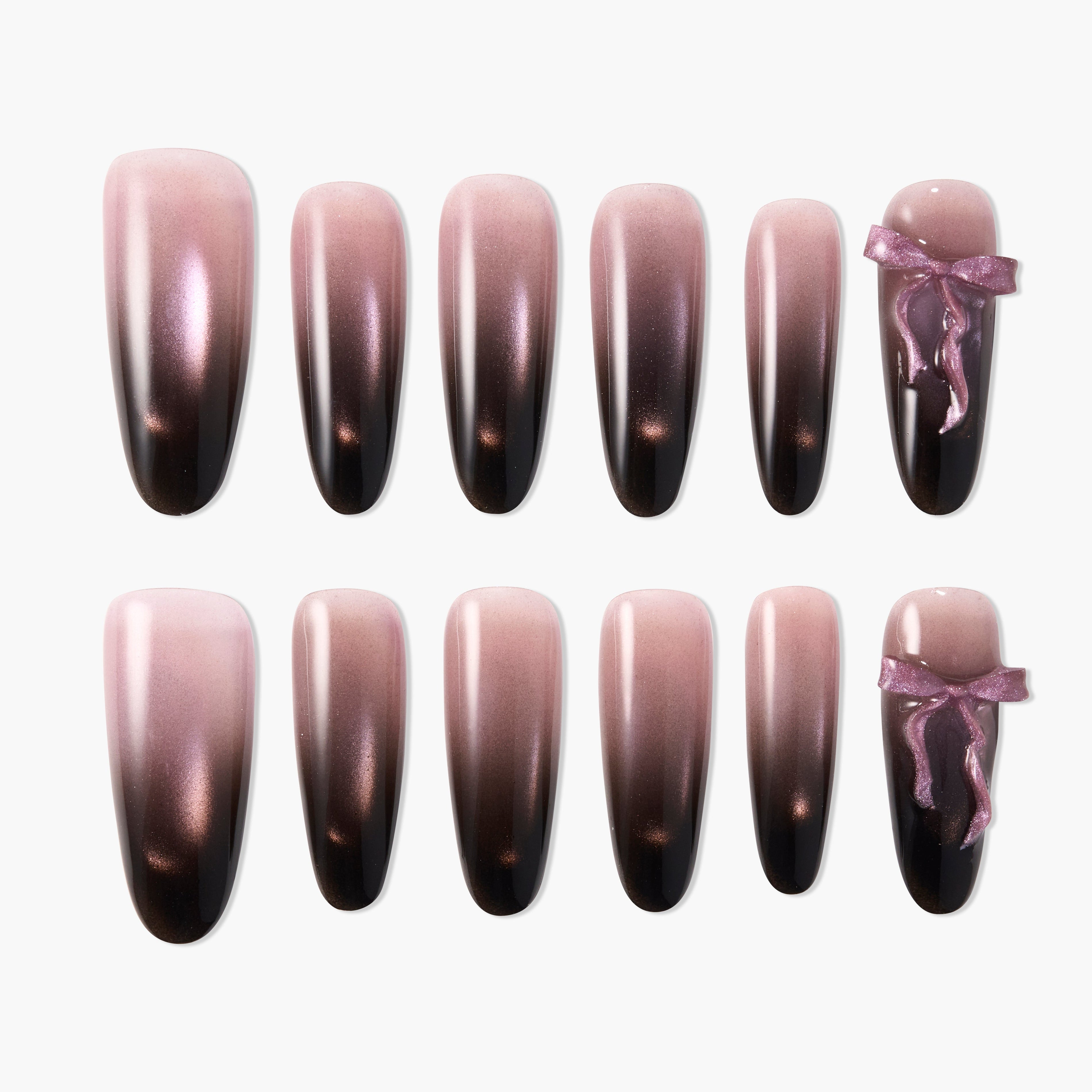 Ombre pink and black press-on nails set with glossy finish and two accent bow designs.