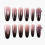 Ombre pink and black press-on nails set with glossy finish and two accent bow designs.