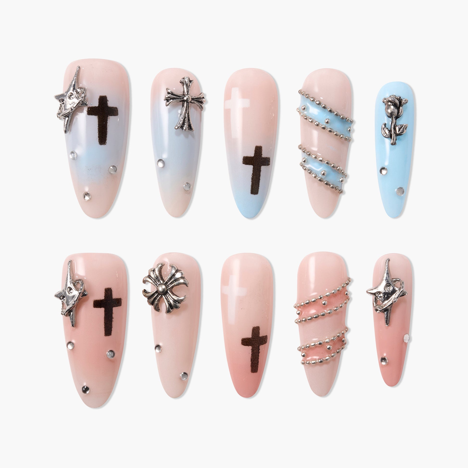 Handmade press-on nails with cross charms, star embellishments, and pastel blue-pink ombre design