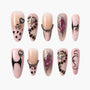 Handmade press-on nails with nude, black, and pink animal prints, metallic accents, 3D charms, and abstract designs.