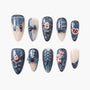 Handmade press-on nails with blue and cream patterns, 3D bows, teddy bears, and heart designs.