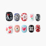 Handmade press-on nails with floral, heart, and star designs in assorted colors