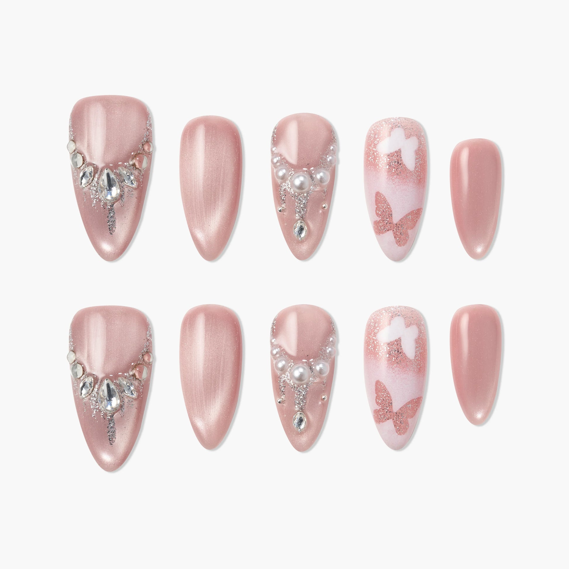 Pink press-on nails with pearl and gem accents, butterfly and glitter nail art designs