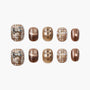 Handmade press-on nails with brown, gold, plaid, bow, pearl, and polka dot designs