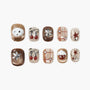 Handmade press-on nails with brown, red, and cream designs featuring stars, bows, and 3D accents.