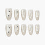 Pearl white press-on nails with silver glitter, star accents, and bow design, glossy finish