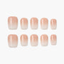 Set of nude ombre press-on nails with a glossy finish on white background