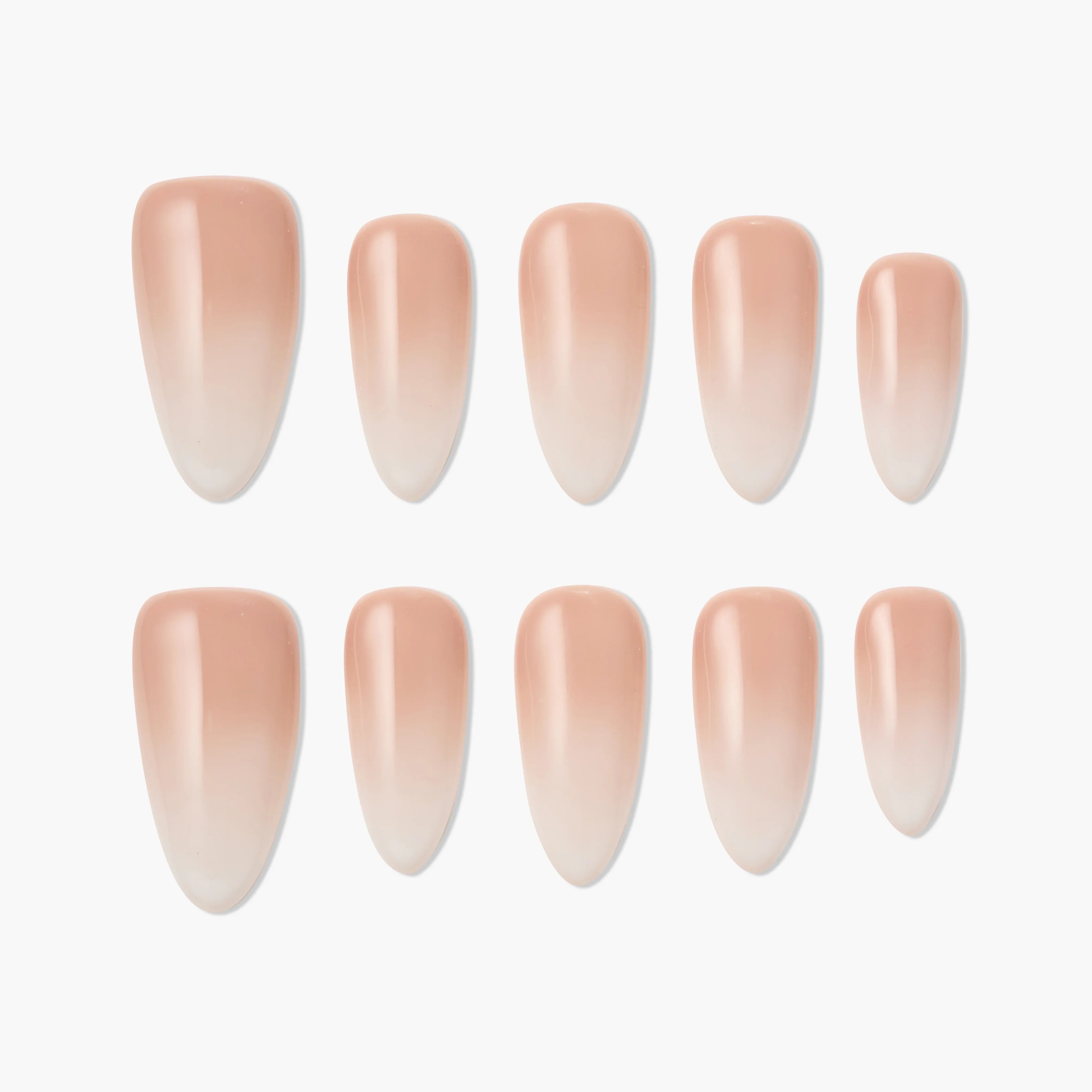 Set of nude ombre press-on nails in an almond shape, arranged on a white background.