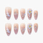 Handmade press-on nails with pink ombre, 3D purple floral accents, rhinestones, and glitter.