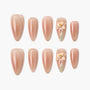 Handmade nude press-on nails with subtle shimmer and 3D floral accent design