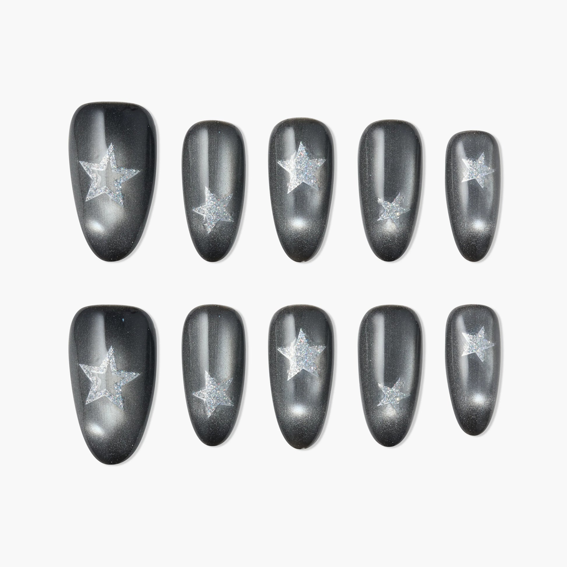 Glossy black press-on nails with glittery silver star design, displayed on white background.
