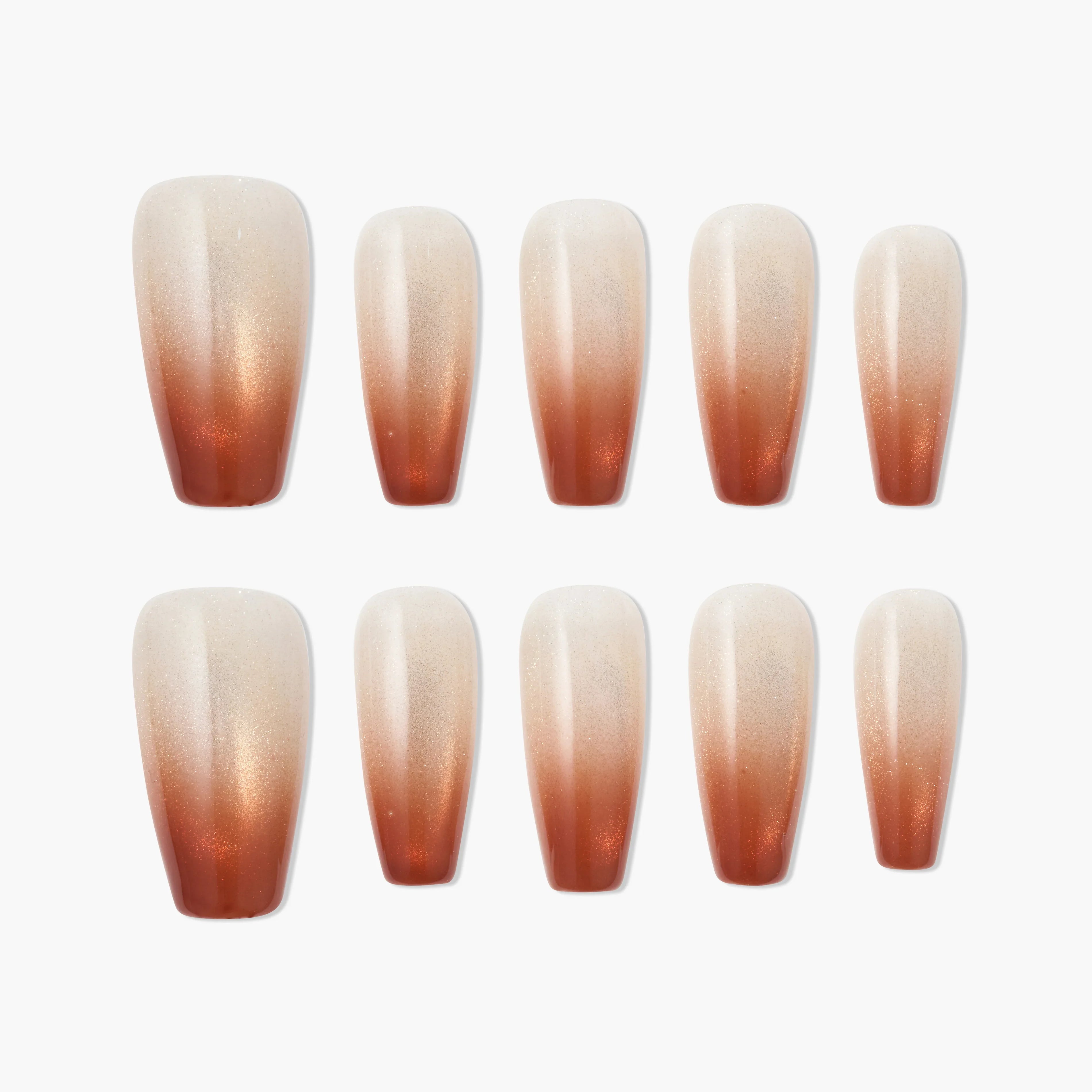 Set of handmade press-on nails with shimmery brown to nude ombre design on white background