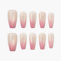 Set of pink and nude ombre press-on nails with a glossy finish, arranged on a white background.