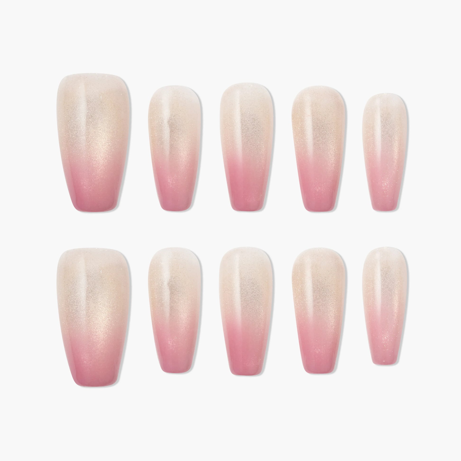 Set of pink and nude ombre press-on nails with a glossy finish, arranged on a white background.
