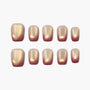 Set of gold and burgundy ombre press-on nails with a glossy finish on white background
