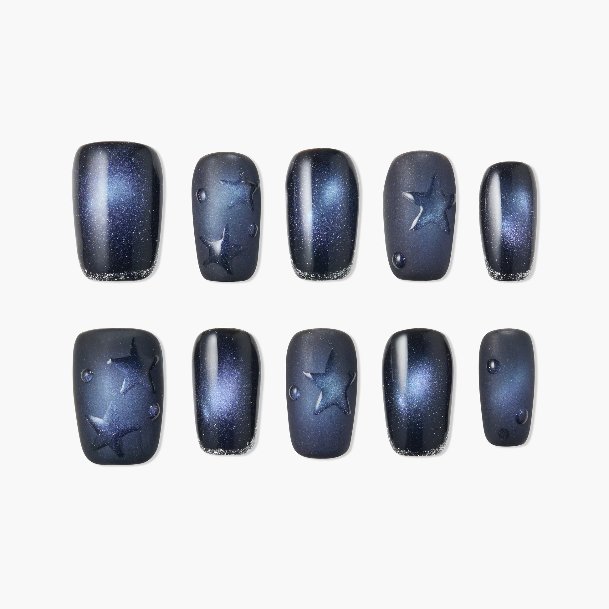 Handmade press-on nails with dark blue galaxy design, star accents, and glossy finish