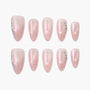 Handmade pink press-on nails with glitter and rhinestone accents, displayed on white background.