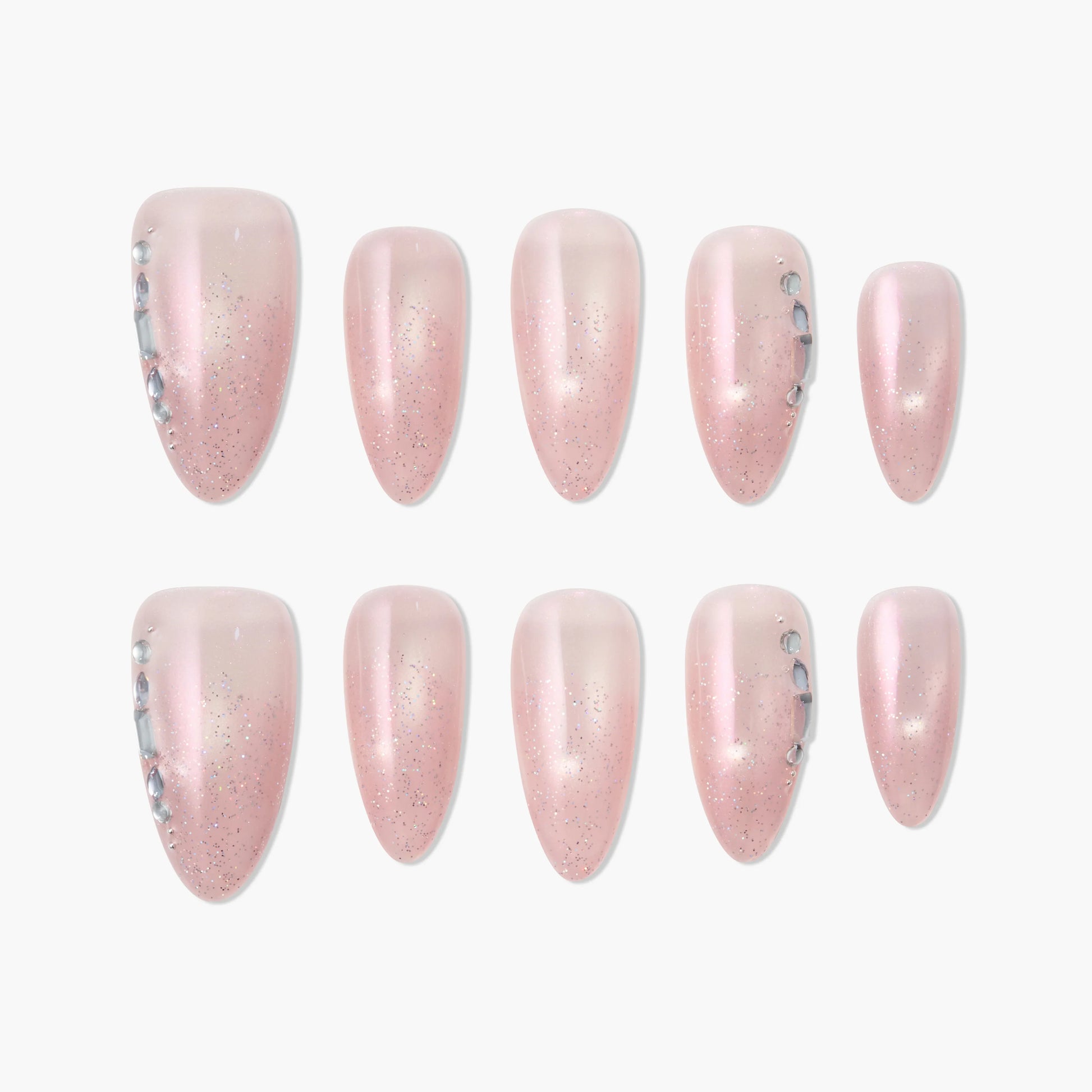 Handmade pink press-on nails with glitter and rhinestone accents, displayed on white background.