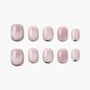 Set of glossy pink handmade press-on nails with subtle shimmer and curved accent tips