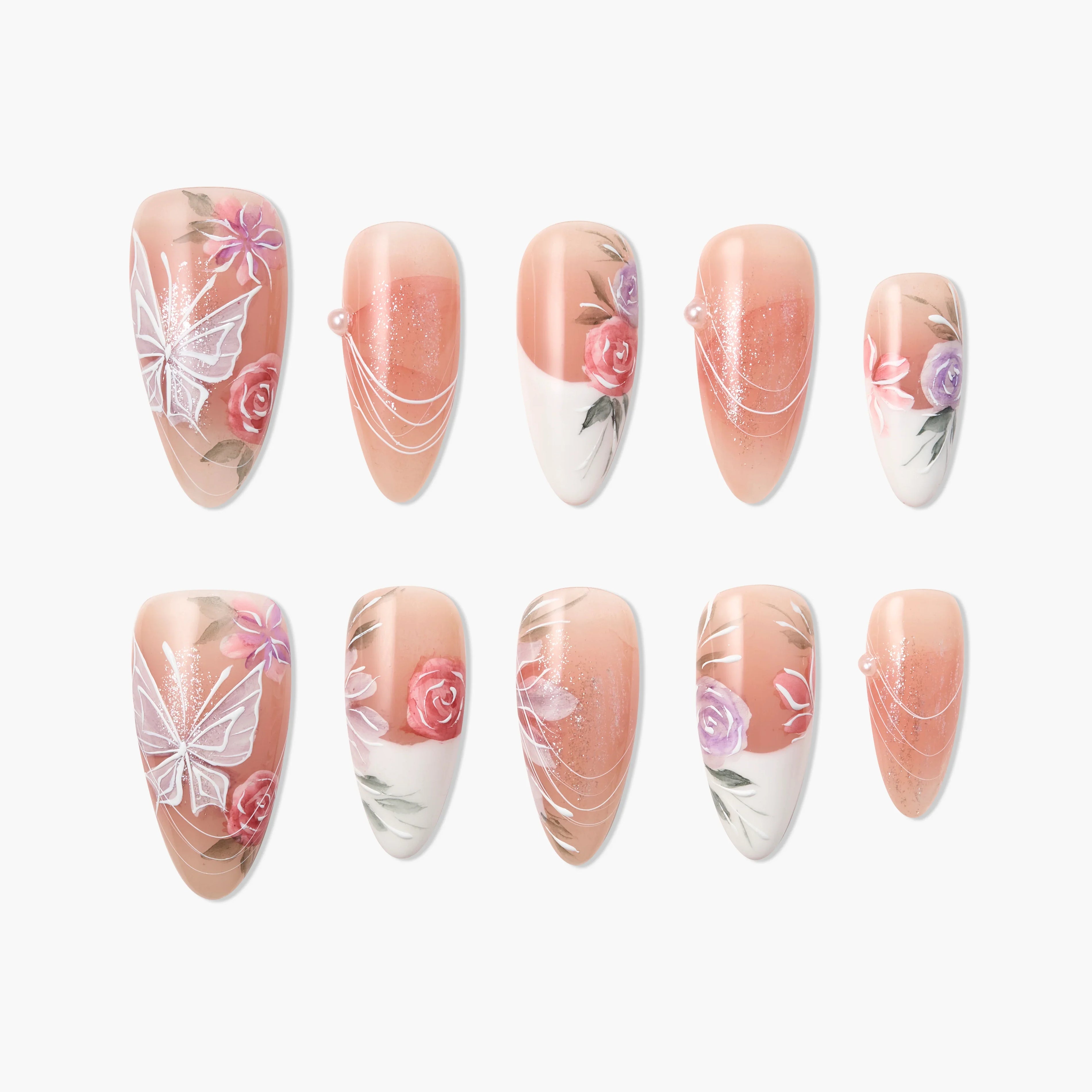 Handmade press-on nails with floral designs, butterfly art, and pearl accents on nude base