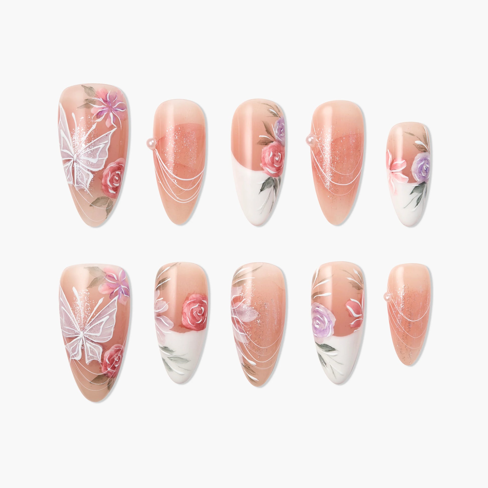 Handmade press-on nails with floral designs, butterfly art, and pearl accents on nude base