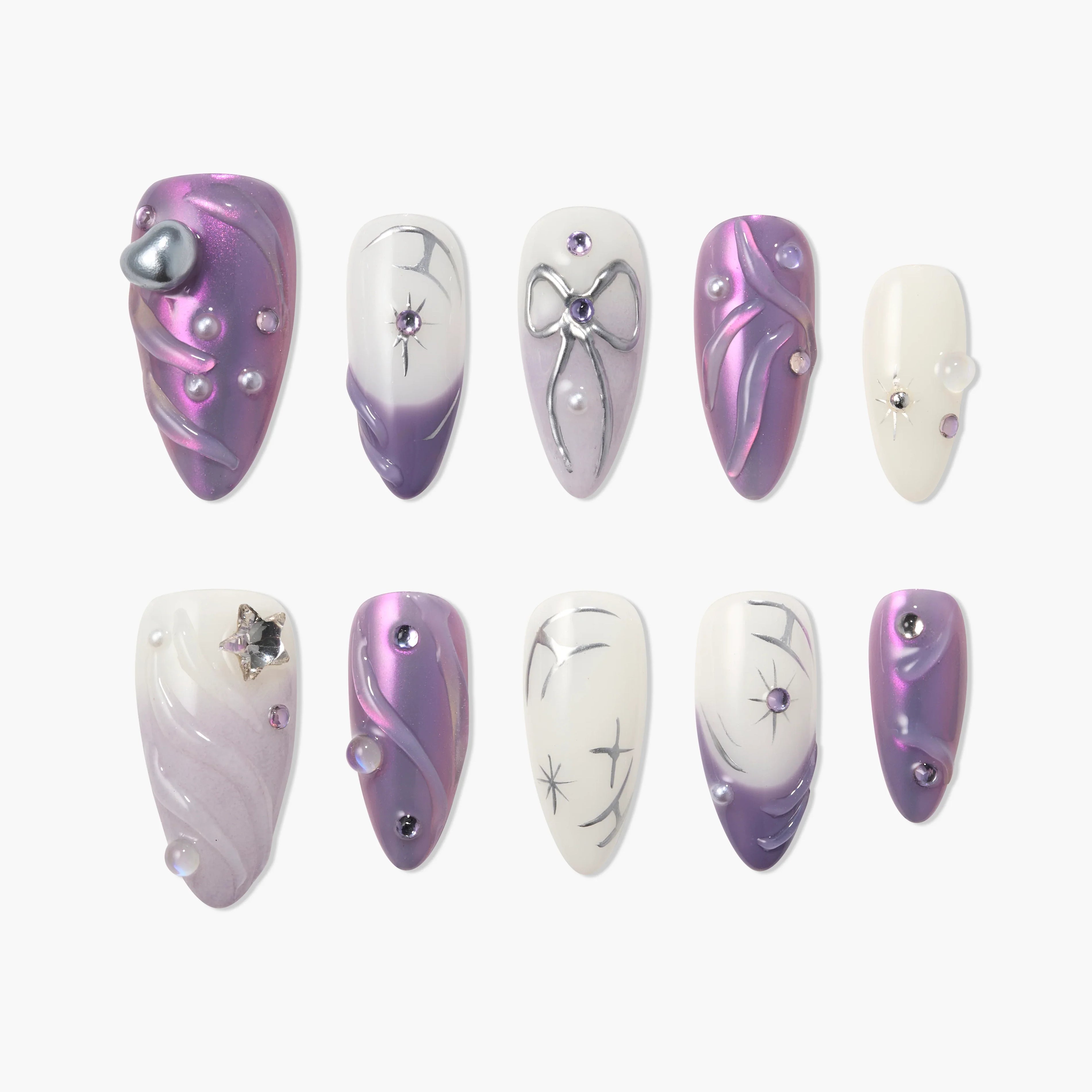 Handmade press-on nails in pearl white and purple with bow, stars, and gem accents