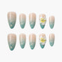 Ombre blue and nude press-on nails with 3D white flower accent and glitter