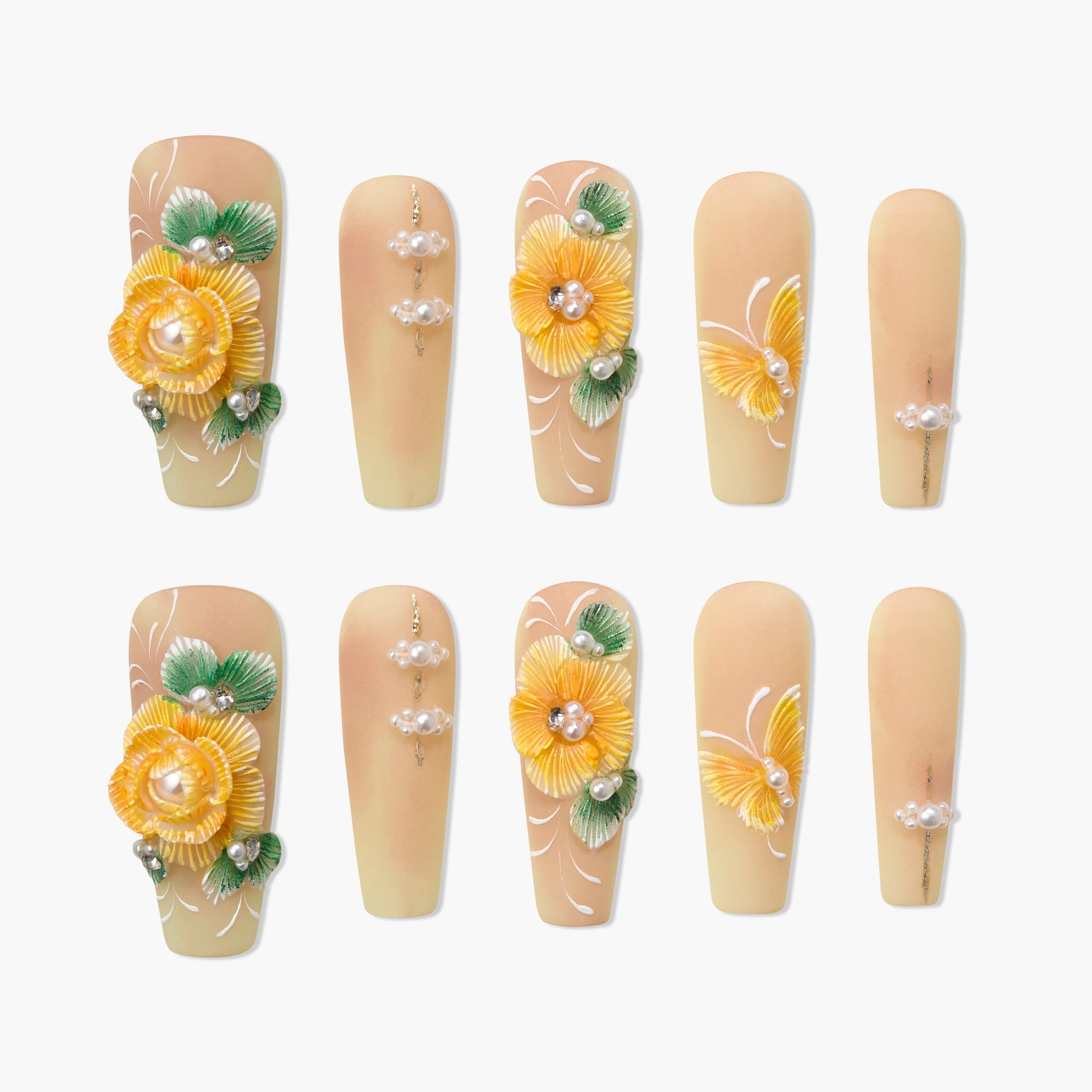 Handmade press-on nails with yellow 3D floral designs, pearls, and green leaf accents