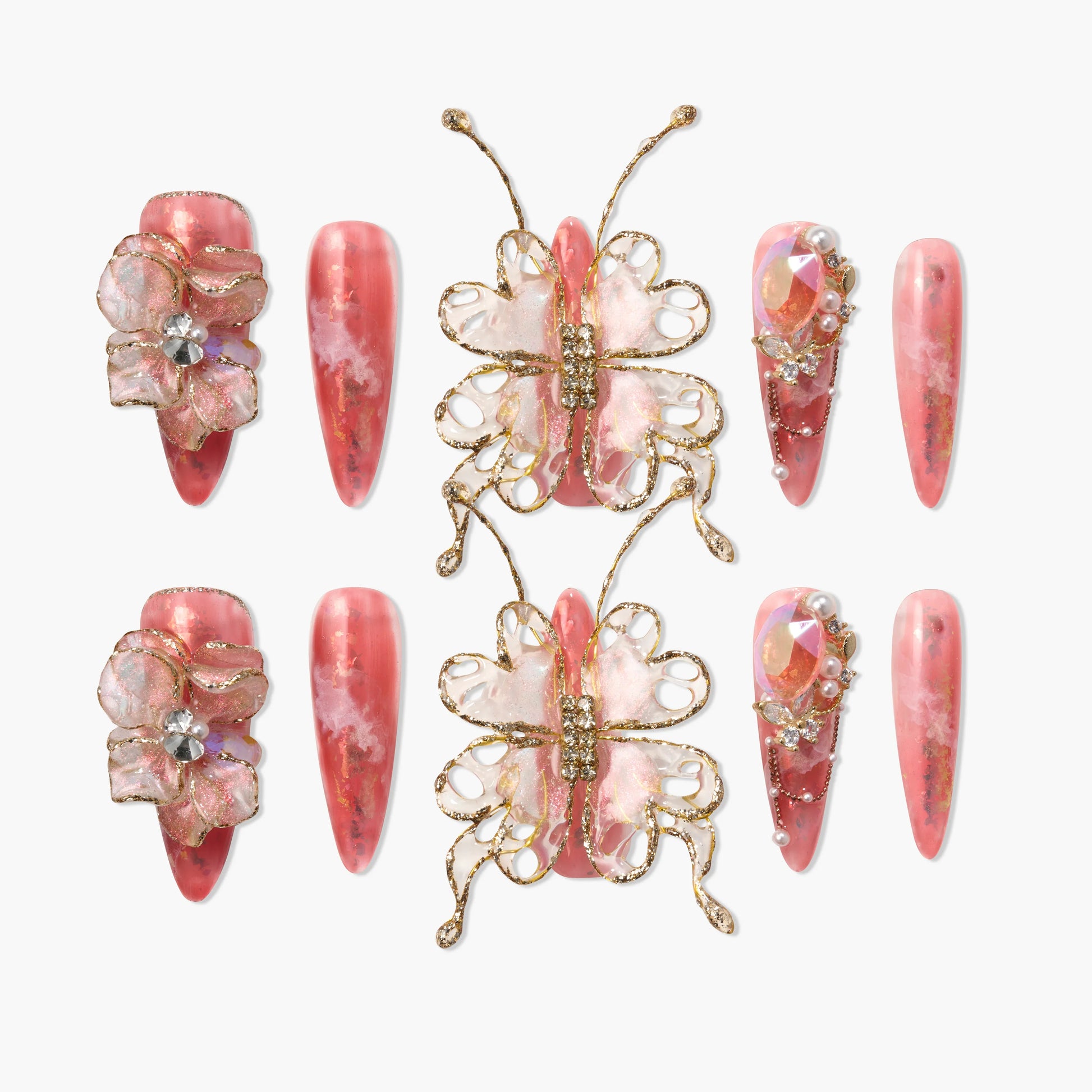 Handmade pink press-on nails with 3D butterfly, flower, and jeweled accents on white background