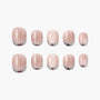 Set of glossy nude pink press-on nails with a subtle shimmer on a white background