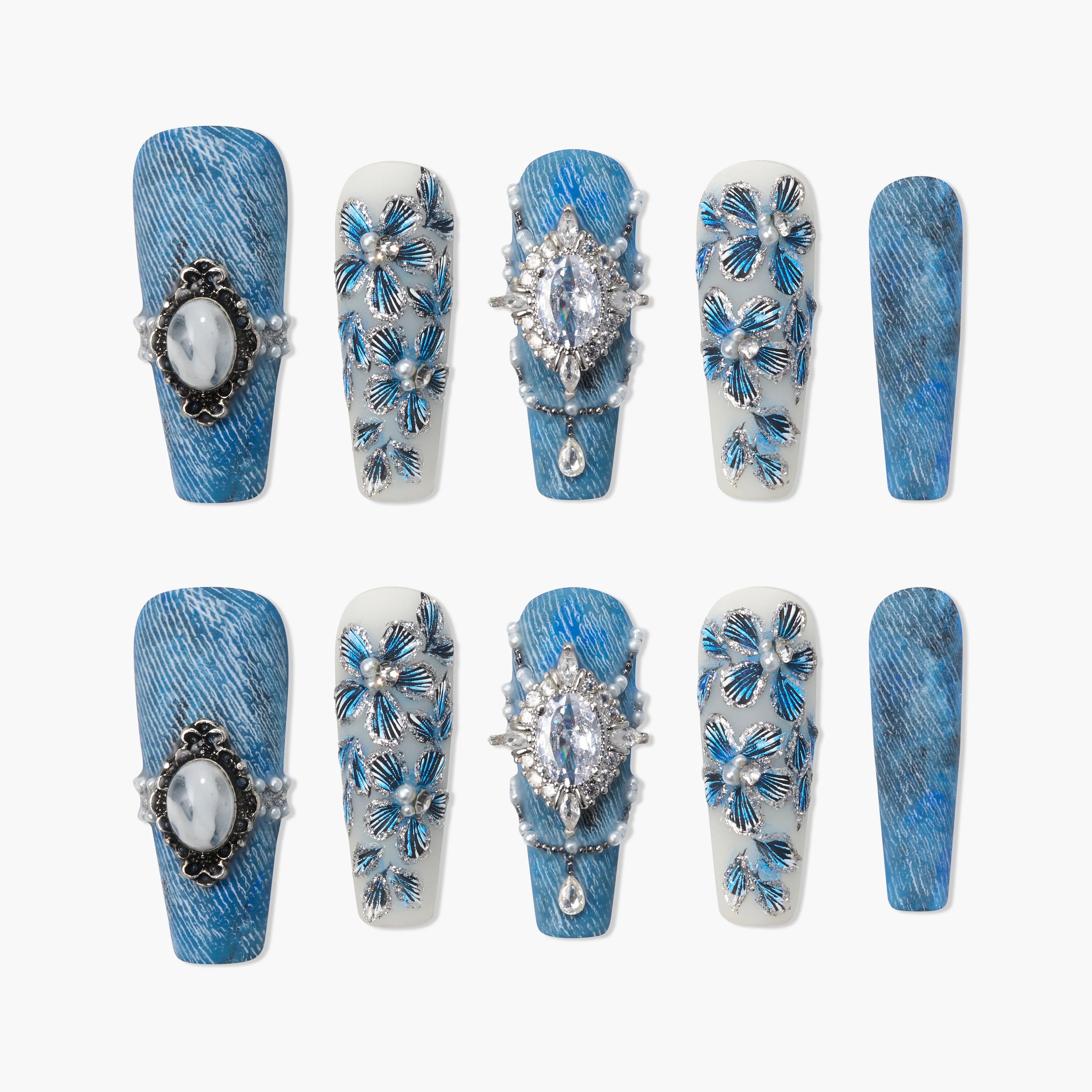 Blue press-on nails with gemstone accents and floral 3D designs, denim texture style