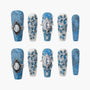Blue press-on nails with gemstone accents and floral 3D designs, denim texture style