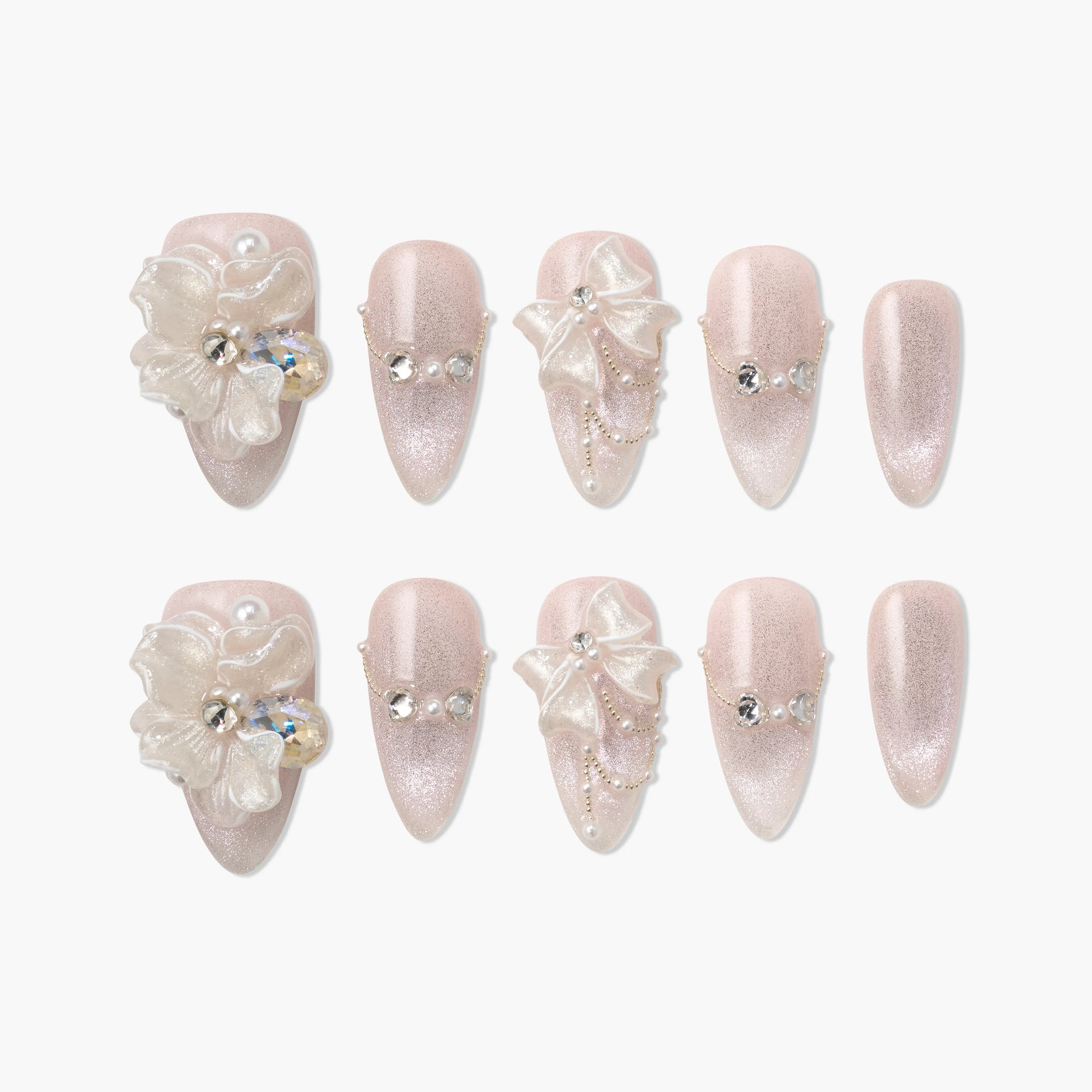 Pink glitter press-on nails with 3D floral and bow designs, pearls, and rhinestones accents.