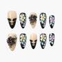 Handmade press-on nails with 3D floral designs, black and nude colors, pearl accents