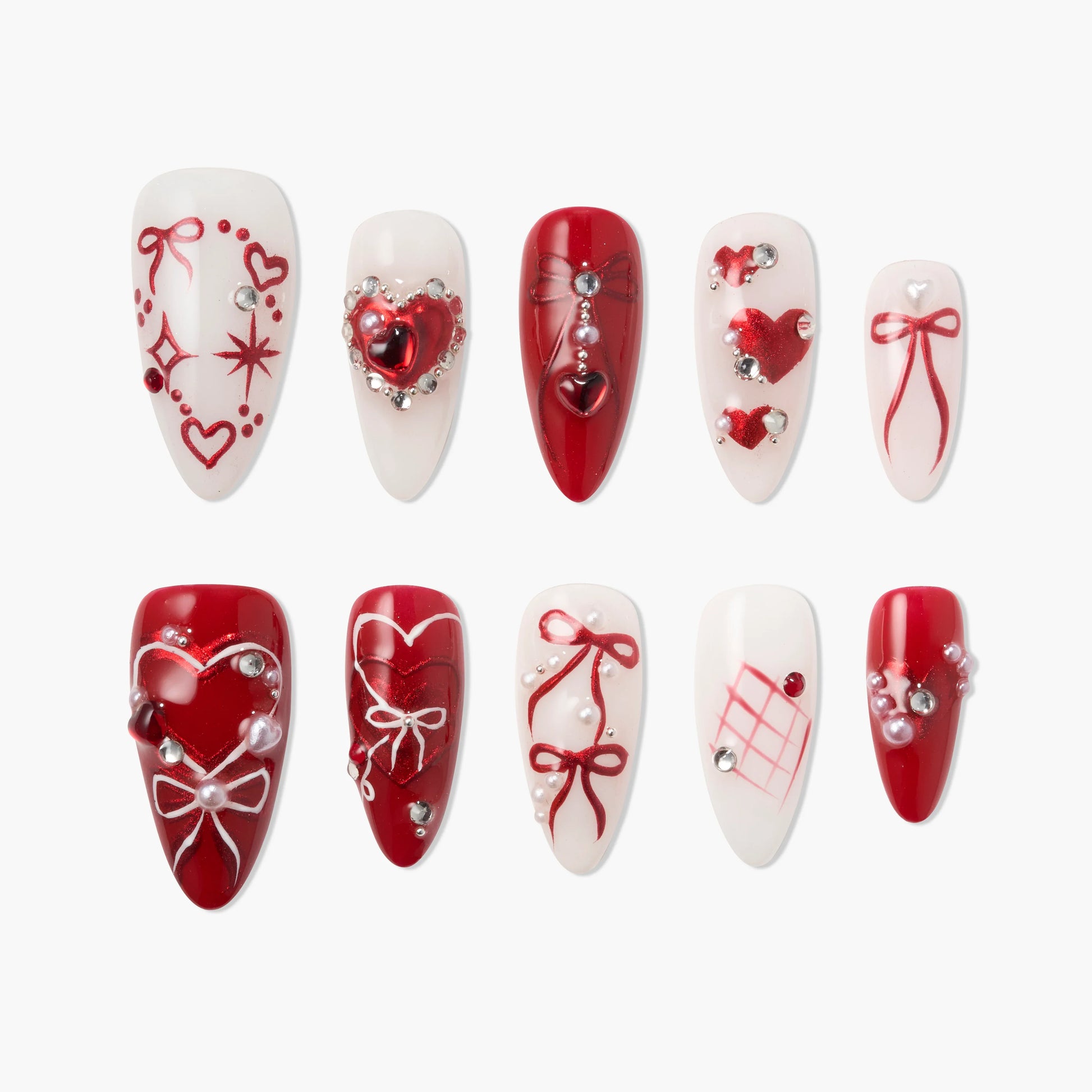 Handmade press-on nails set with red and white heart, bow, and gem designs