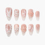 Pink floral press-on nails with 3D flower accents and delicate white painted designs