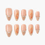 Handmade press-on nails with nude base, gold glitter tips, pearl accents, and orange floral art.