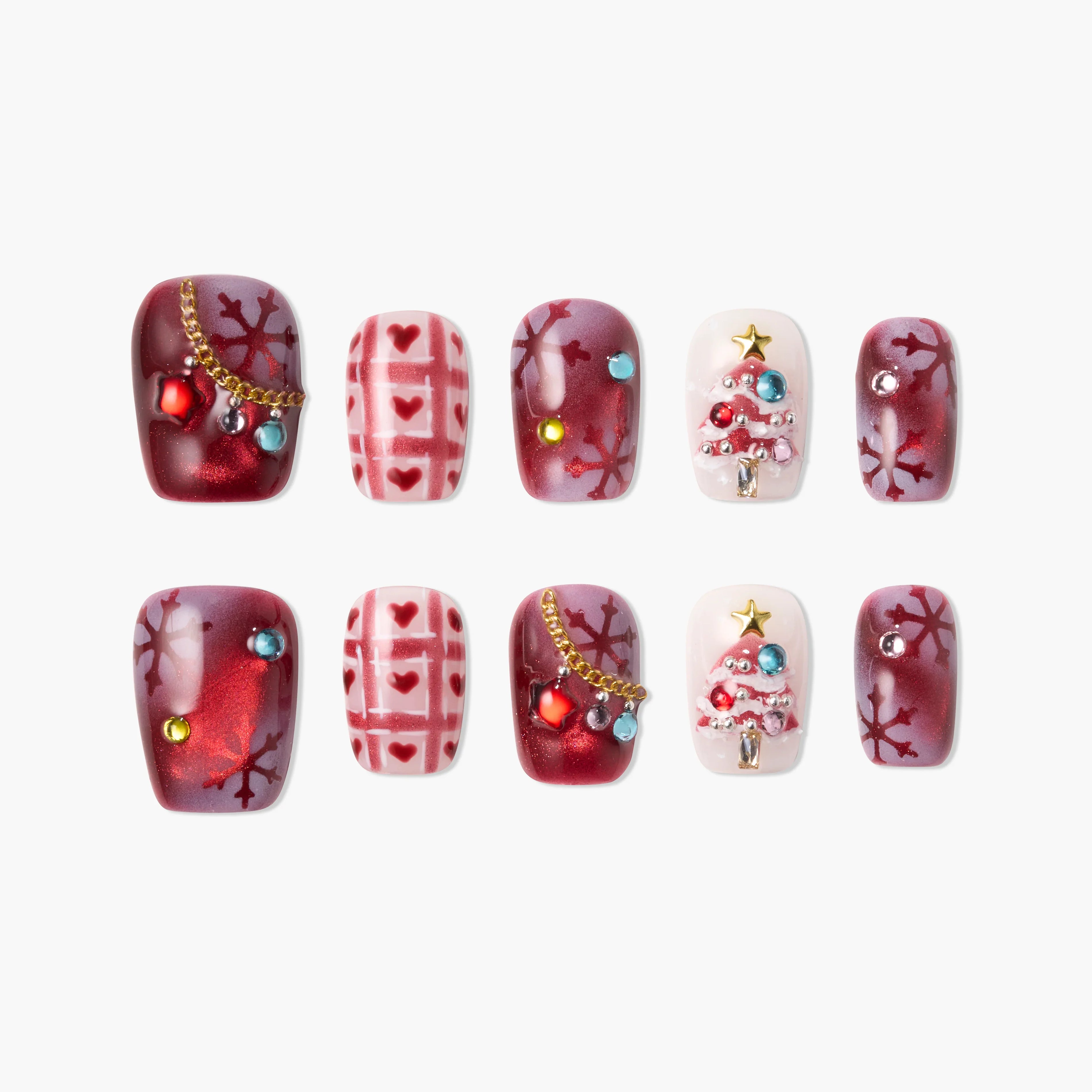 Handmade Christmas press-on nails with red snowflakes, hearts, and 3D Christmas tree designs